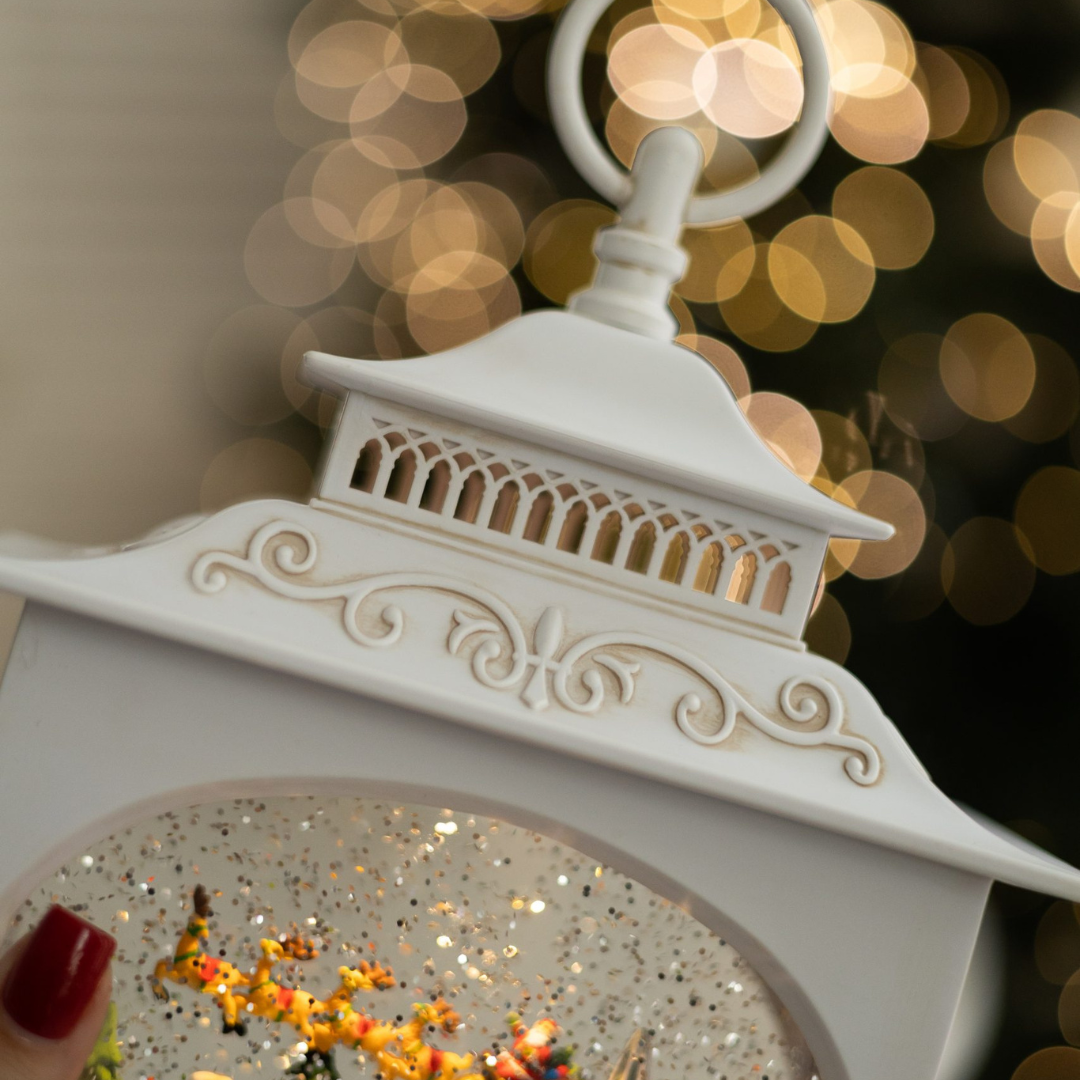 Decorative white lantern with glittery interior against a blurred bokeh background