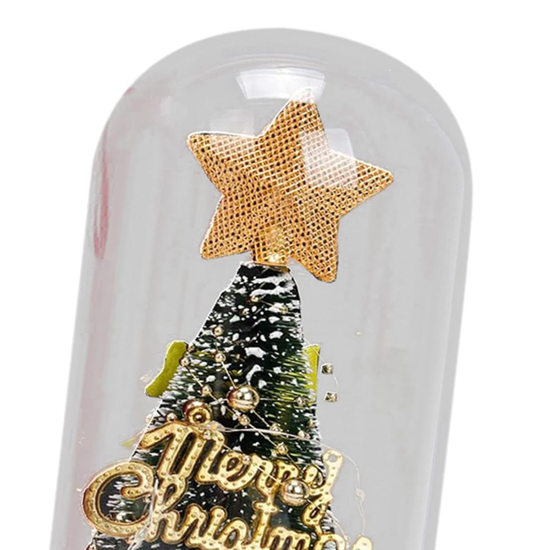 Decorative Christmas tree with gold star and 'Merry Christmas' text under a glass dome.