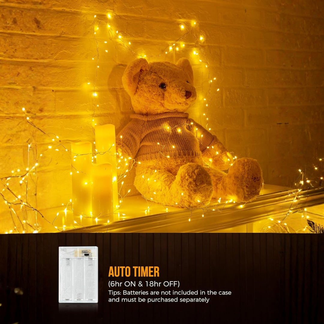 Teddy bear with string lights against a brick wall, featuring an auto timer.