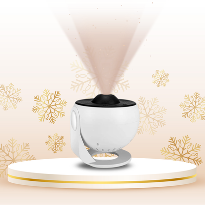 White and black device emitting a light pattern on a beige background with gold snowflake designs