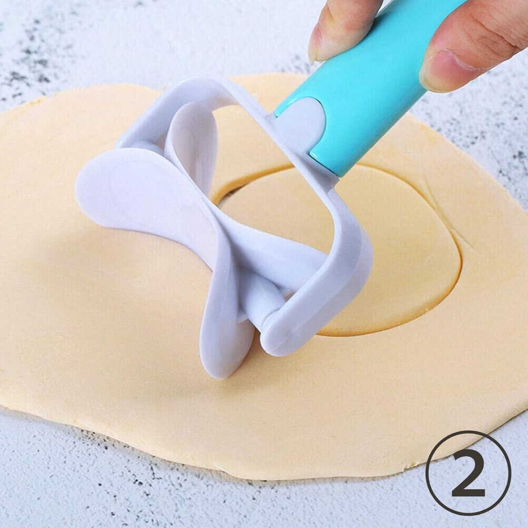 Rolling pin with a dough roller cutter on a piece of dough.