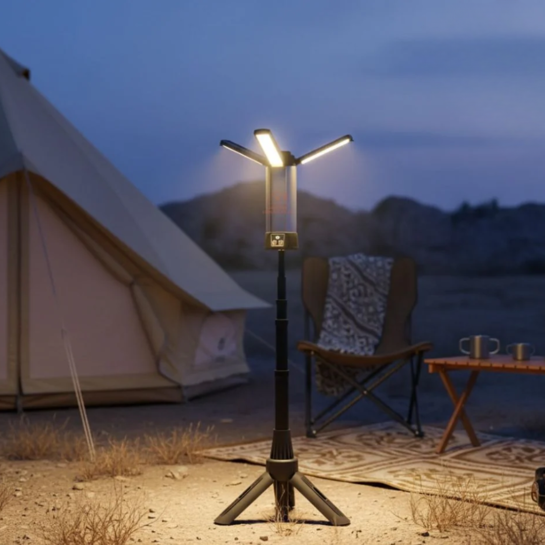 Camping scene with a lit lamp, chair, and tent in the evening.