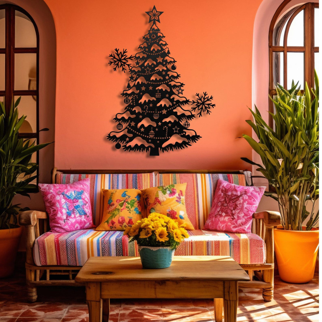 Decorative black Christmas tree wall art on an orange wall above a colorful sofa with floral and patterned cushions.