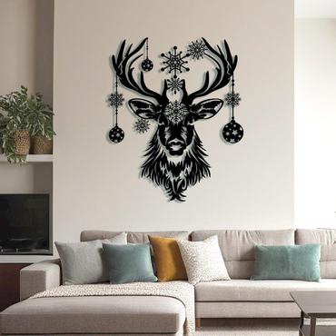 Black deer head wall decal with snowflakes on a beige wall above a sofa.