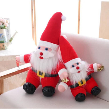 Two red Santa Claus plush toys sitting on a light-colored surface.