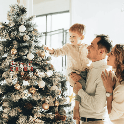 Family decorating a Christmas tree with ornaments