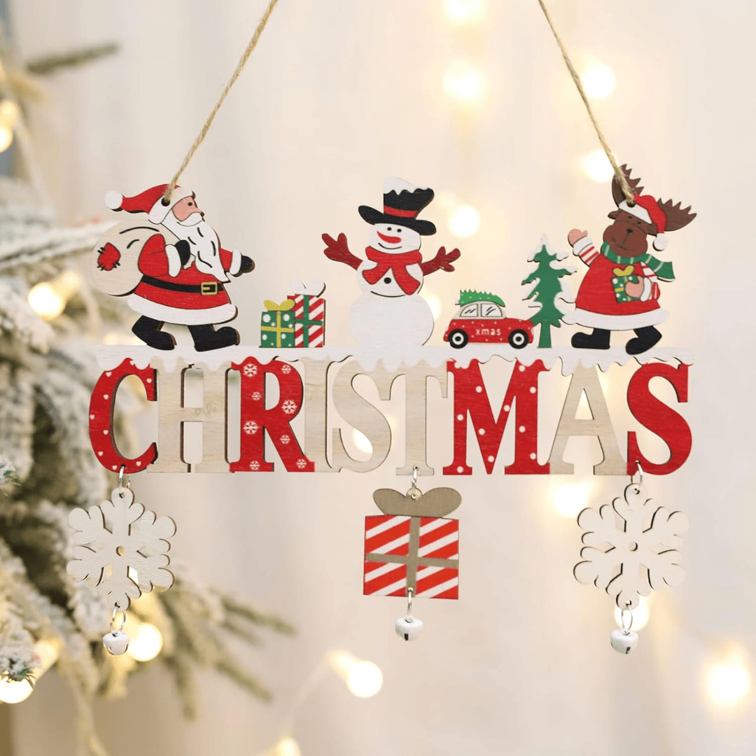 Decorative Christmas sign with Santa, snowman, reindeer, and snowflakes hanging against a light background.